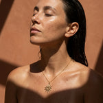 Summer necklace with gold-tone sunburst pendant on thin chain