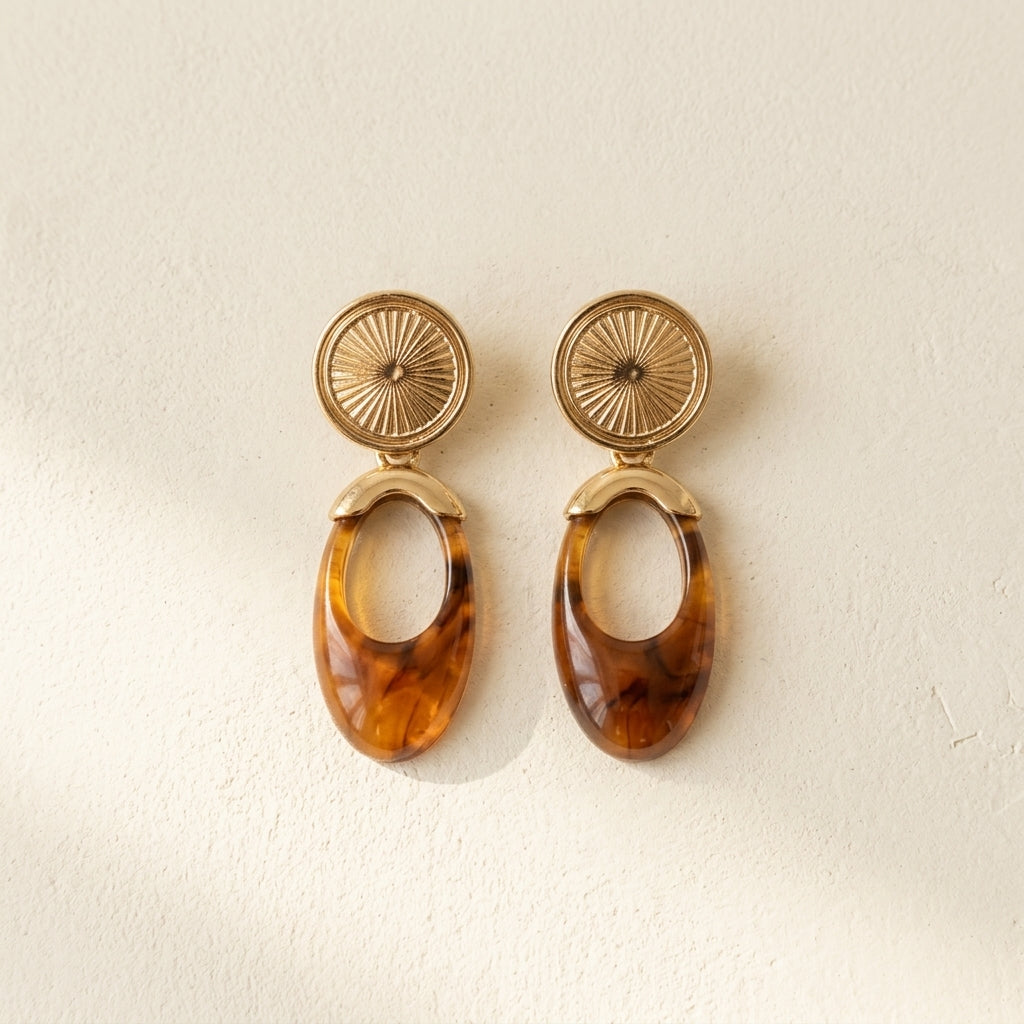 Pair of TERRA earrings with textured gold disks and amber oval drops
